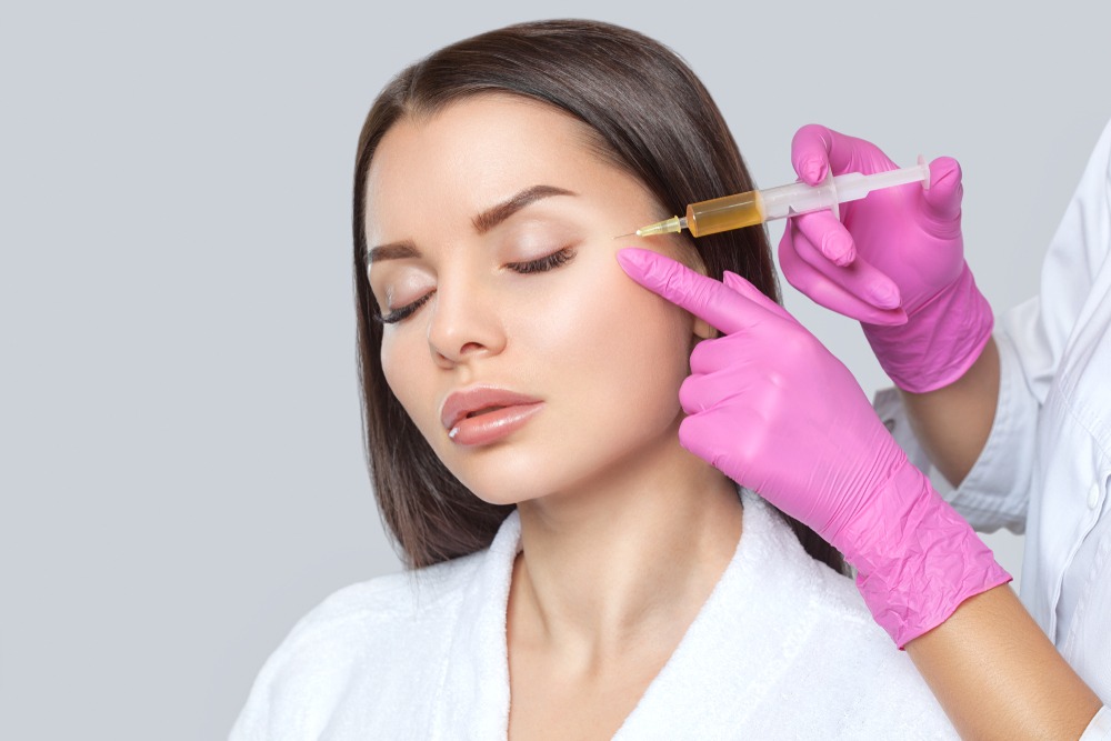 woman receives platelet-rich plasma facial injection